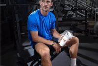 Tennis Professional Tommy Paul sitting on workout bench