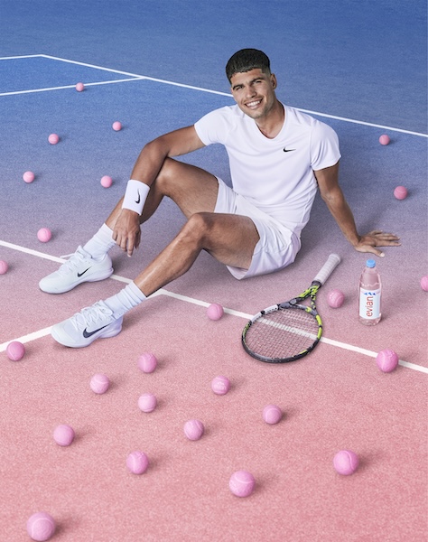 Carlos Alcaraz posing on pink tennis court in evian promo