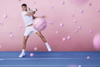 Carlos Alcaraz hitting pink tennis ball in evian promo