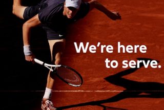 Jannik Sinner serving on a clay court in a promo for Allianz