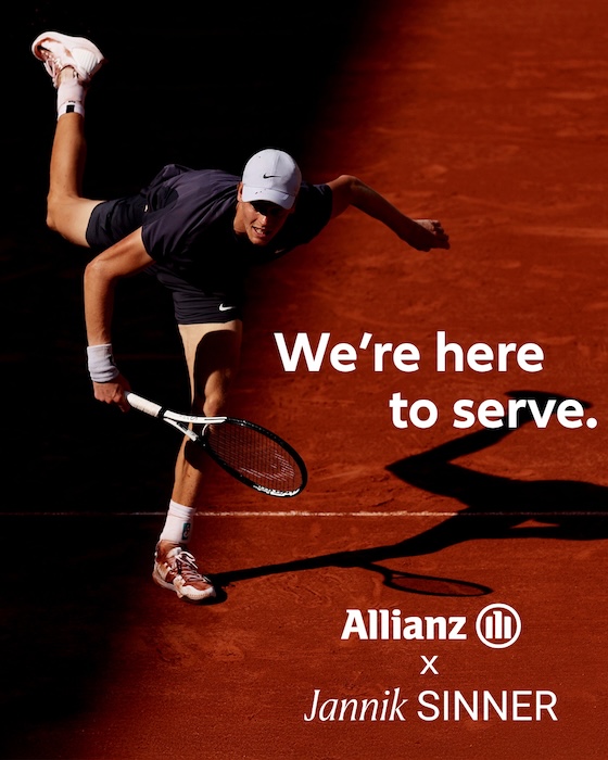 Jannik Sinner serving on a clay court in a promo for Allianz