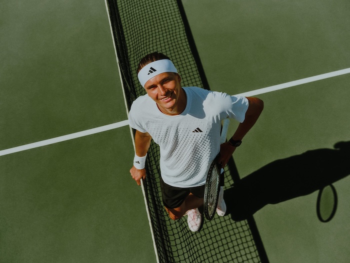 Alexander Zverev looking up from tennis court